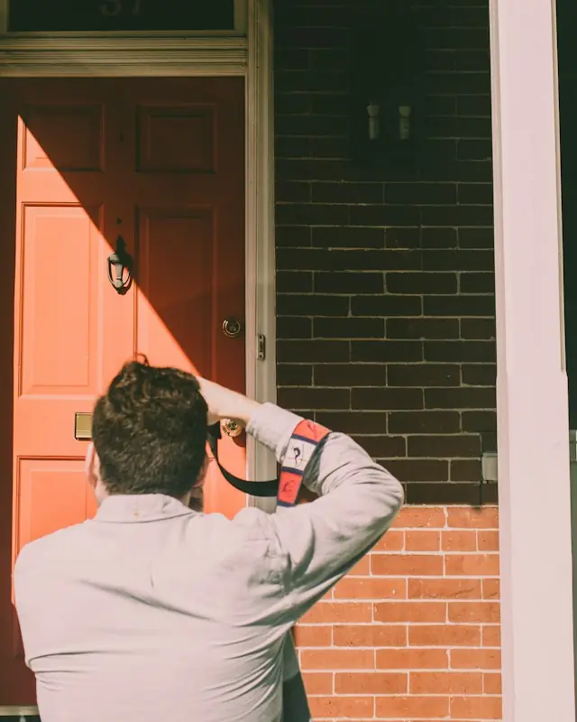 A surveyor photographing the front of a house